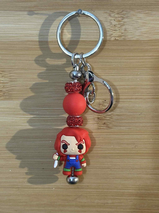 Evil kid doll in red keychain
